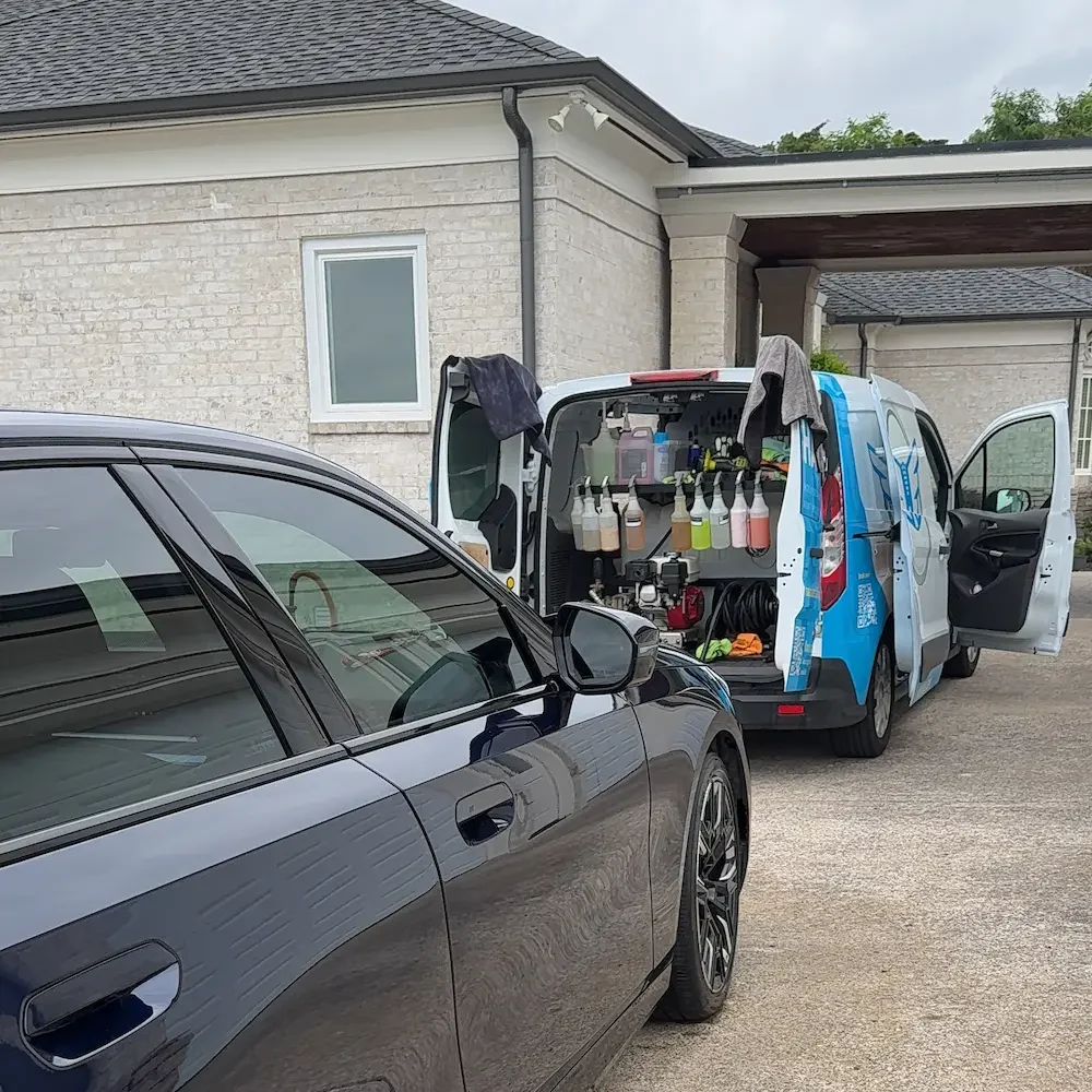Halo Mobile Detailing van with professional equipment parked in a Spring Hill driveway next to a sedan